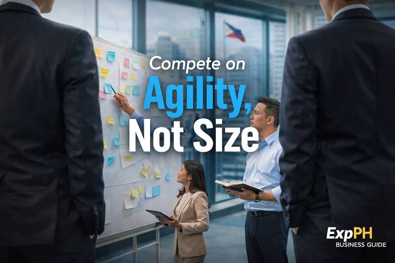 Filipino small business team planning strategies on a whiteboard to compete with larger companies through agility and innovation