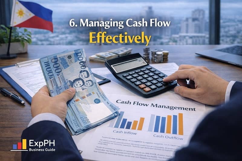 Managing cash flow effectively in the Philippines with business owner reviewing cash flow chart, calculator, and Philippine peso money on desk